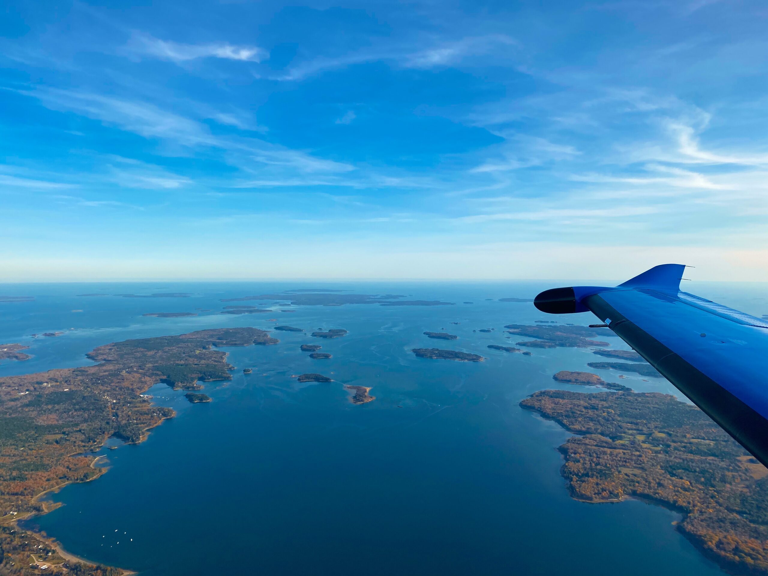 Pilatus aircraft flying over Maine coast
